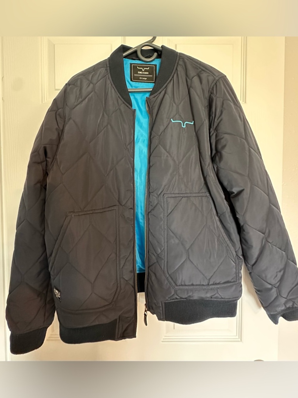 Kimes Ranch Quilted Bomber Jacket in Black with Teal Lining